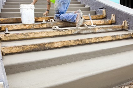 Field of Dreams Landscaping and Concrete mason building cement steps.